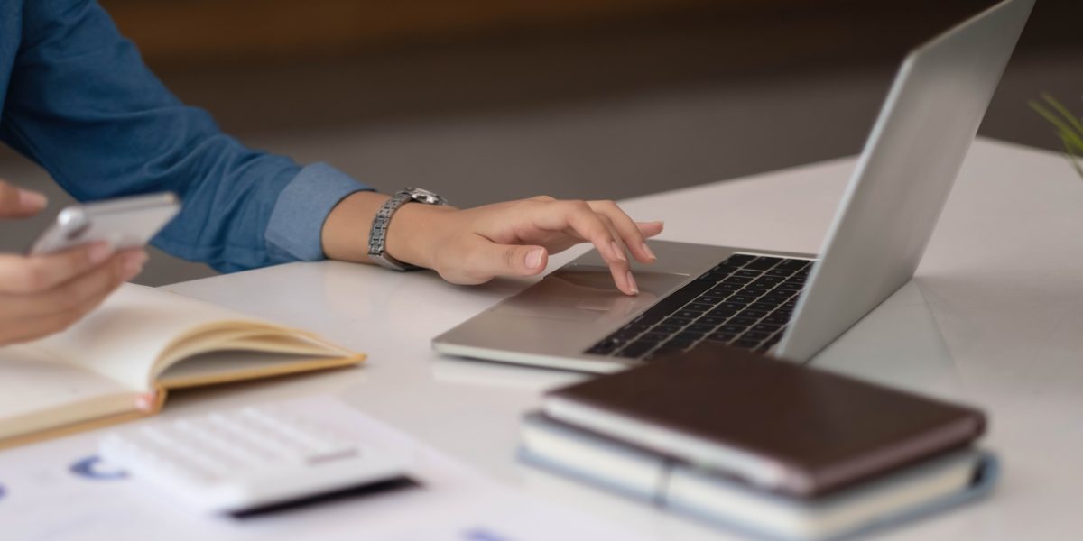 A businesswoman using an online banking program in order to open a digital savings account. The