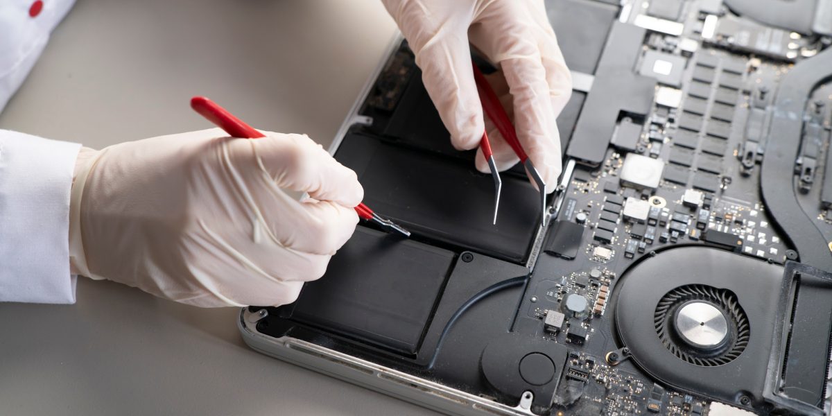 a laptop battery fix, serviceman changing the battery components