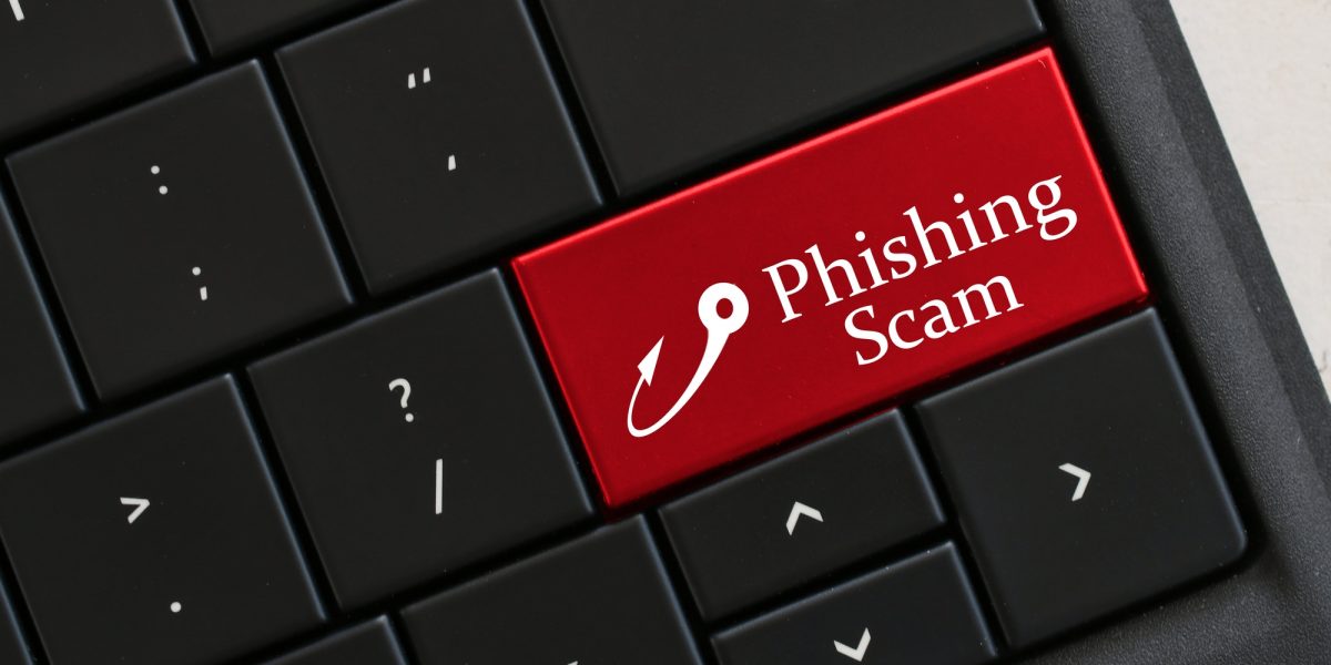Beware of Phishing Scam Emails - Concept - Computer Keyboard with red key that says PHISHING SCAM