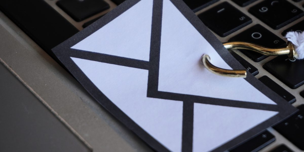 Closeup image of mail with hook on top of keyboard.