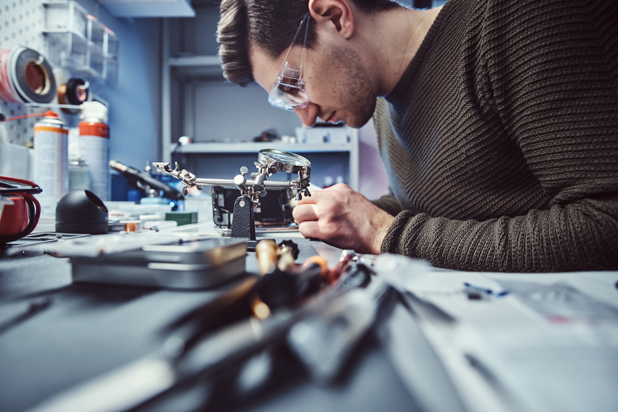 Electronic technician repair damaged smartphone in the workshop