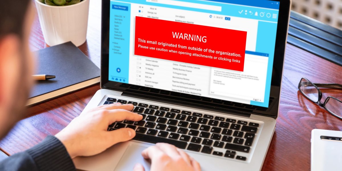 Email attachments warning message on a laptop screen. Computer Virus and Antivirus.