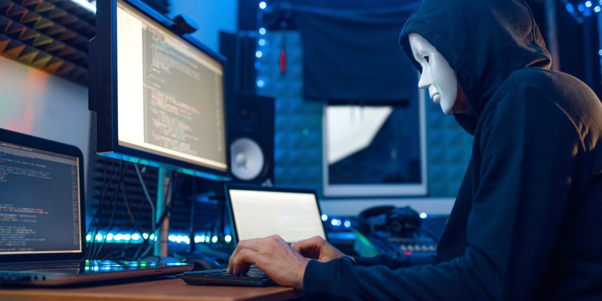 Hacker in mask and hood, account hacking