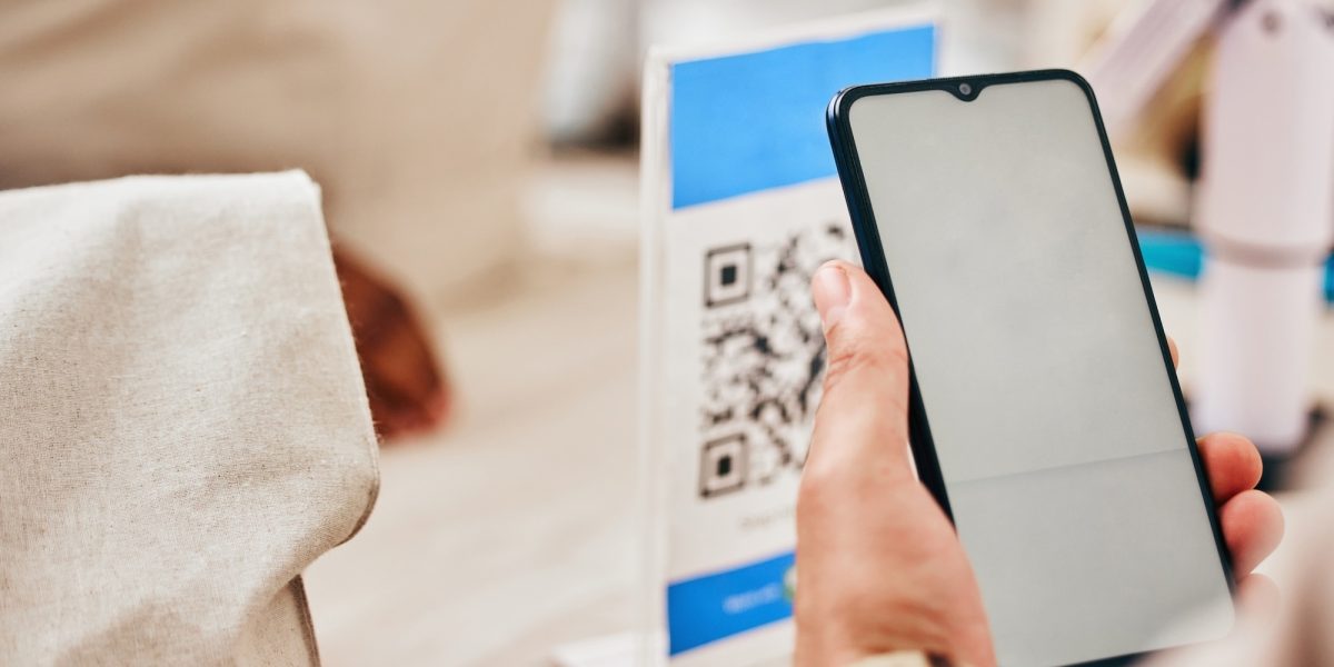 Hands, phone and store to scan qr code for payment, trading or cybersecurity with fintech, service