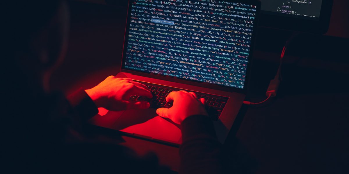 Man using computer and programming to break code. Cyber security threat. Net security
