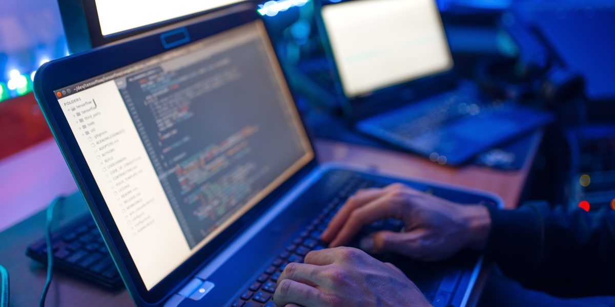 Programmer hands on keyboard, network security