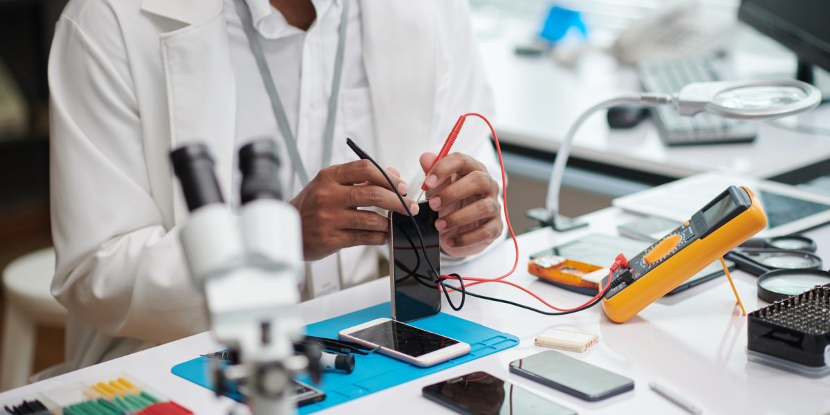 Repairman Checking Smartphone Battery