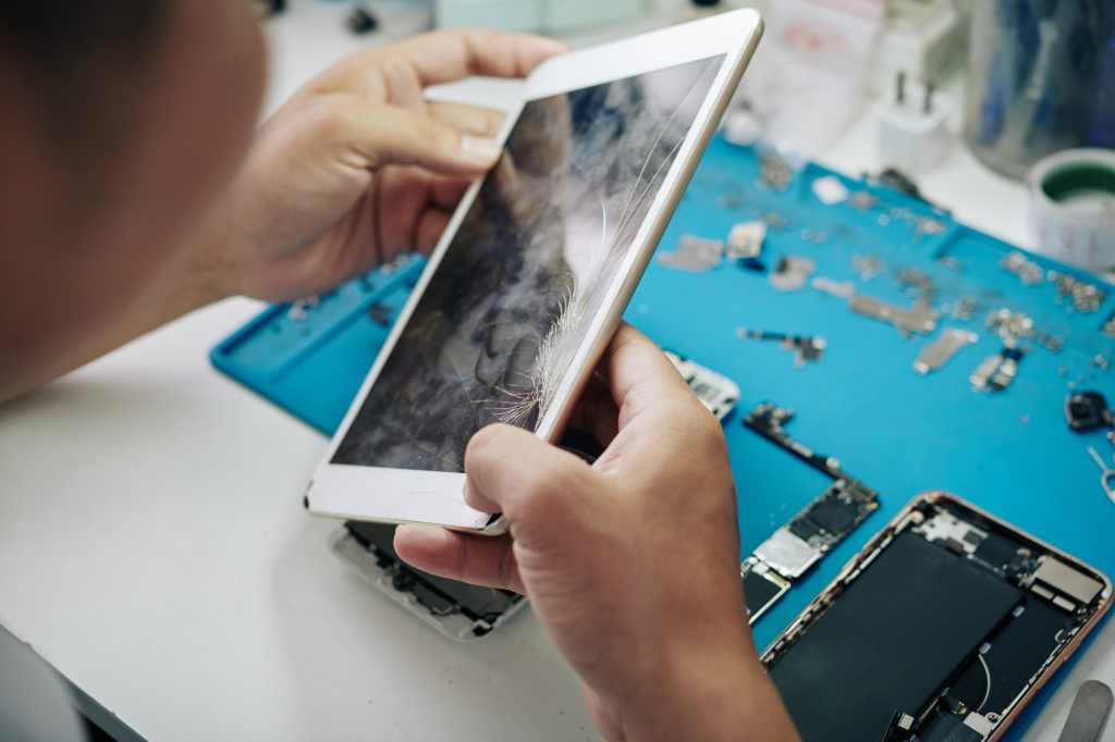 Repairman examining tablet computer