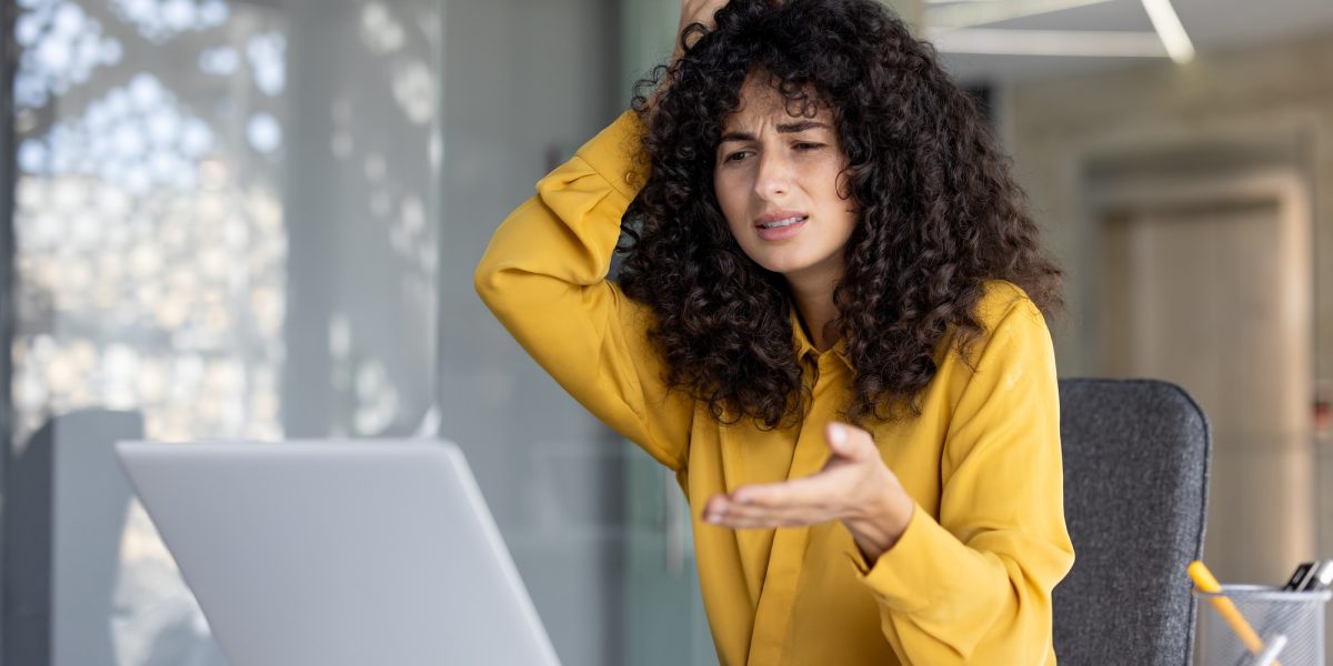 Upset and disappointed woman got error and laptop crash, unsatisfied woman looking at laptop screen